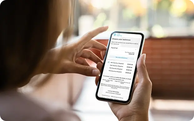 Person holding phone showing account balance